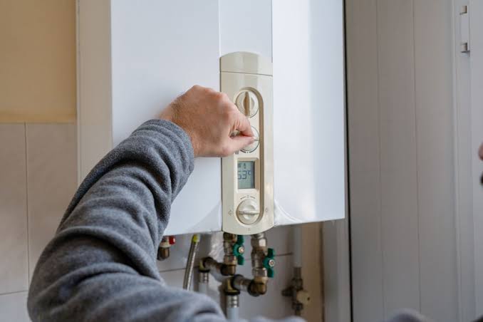 HVAC technician testing mini split electronics and airflow with diagnostic tools