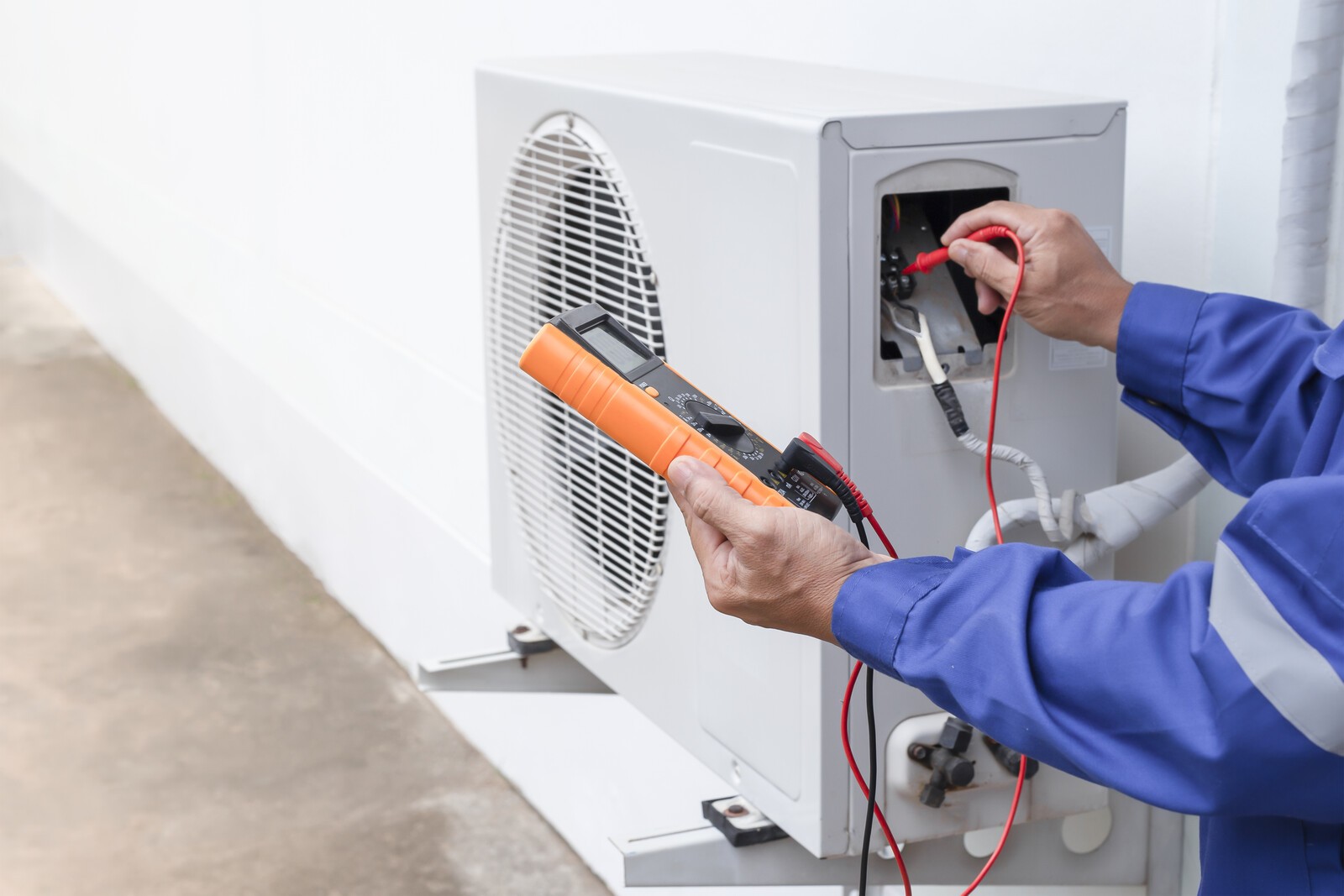 Technician repairing wall-mounted mini split unit in finished bonus room